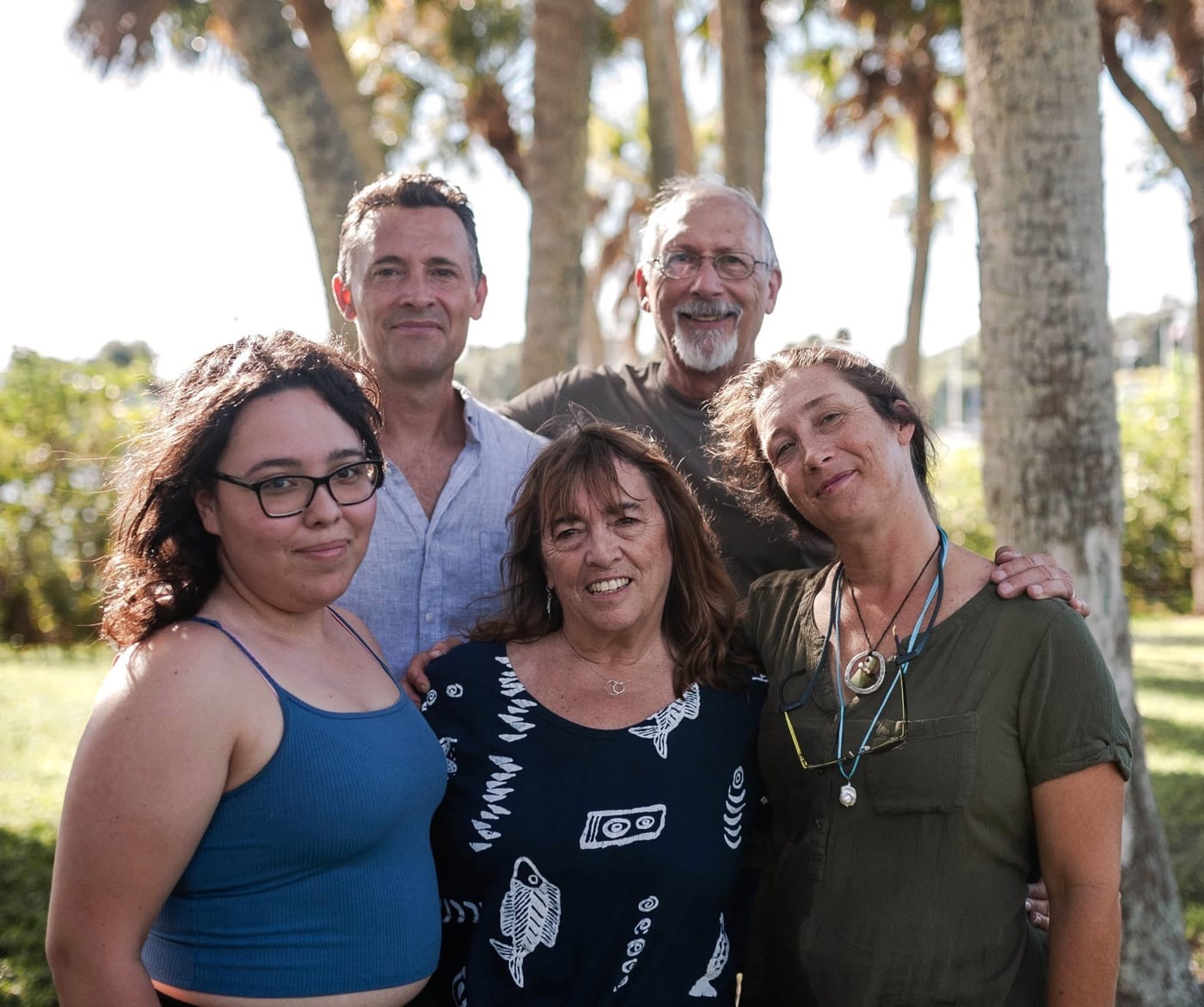 Lynda with her family under the palm trees