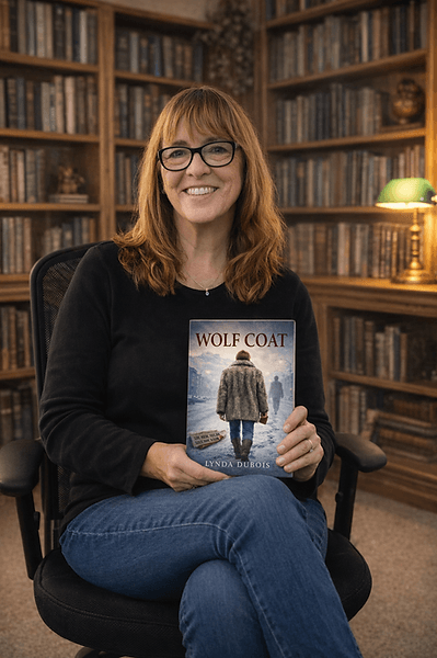 Lynda DuBois holding Wolf Coat in a library